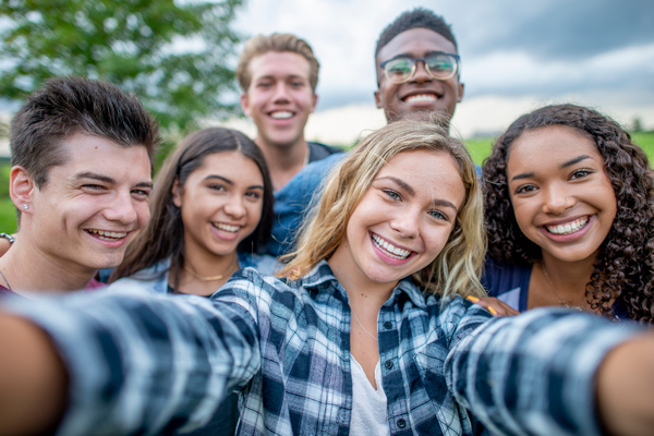 Happy and smiling teenagers taking a group selfie